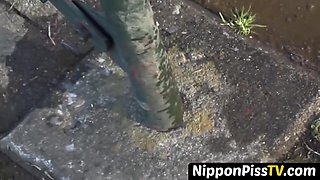 NipponPissTV.com - Short-haired Japanese babe in tracksuit pisses in the street openly