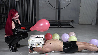 A man scared by balloons bursting and a laughing mistress