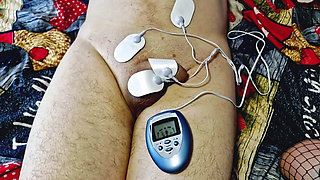 Dominatrix Nika plays with electric discharges on the genitals of the slave. Electrostimulation BDSM