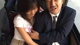 Japanese babe giving a handjob to a businessman on a bus ride