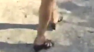 Mel walking on the side of the road