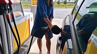 She is refueling at the gas station, showing her tits and pussy