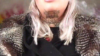 Blonde lady smokes an electronic cigarette