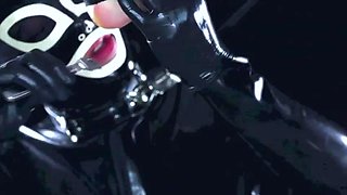 Latex suit male slave licking the feet of his mature mistress