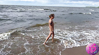 Beauty blonde walking naked on the seashore