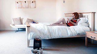 Ella Hughes is a sexy redhead who wears lingerie and uses sex toys.