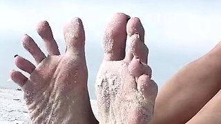 Milf seductress showing off her fabulous feet outdoors