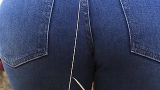 MILF In Blue Jeans Bends Over And Flashing Her Big Ass Outdoors