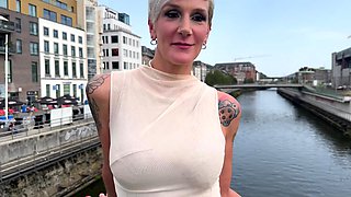Blonde is flashing her big boobs in the outdoors