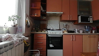 A Sexy Naked Woman Prepares Food in the Kitchen
