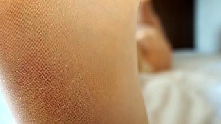 Stretching in Pantyhose on the Bed