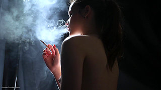 Topless Brunette Smoking in Dramatic Smoke