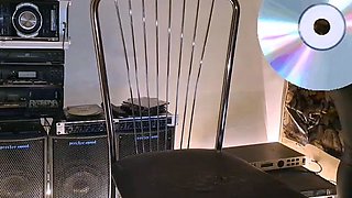 A mature woman in black leggings performs an intense ha