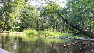 Cute Teen in Costume Playing in the River Like in a Swimming Pool