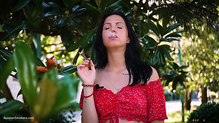 Sultry Brunette in Red Dress Smoking Rolled Cigarette