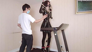 Mz24 - a Girl Bound to a Treadmill with Metal Restraints and Shackles