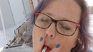 Calm Outdoor Smoking Moment with a Playful Lipstick Look