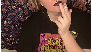 Smoking a cigarette with bold black lipstick