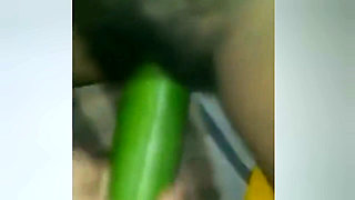A Young Woman Is Inserting a Cucumber Into Her Pussy