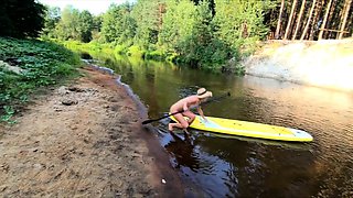 Tattooed Babe Strips and Swims on a SUP Board in the Forest