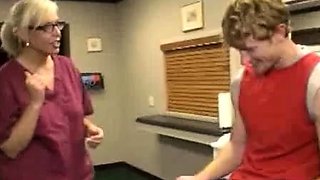 Milf Carey Riley strokes a young guys dick in the office